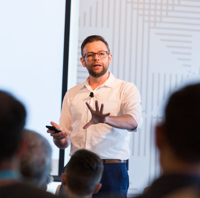 Joe Martin speaking on stage in Chicago